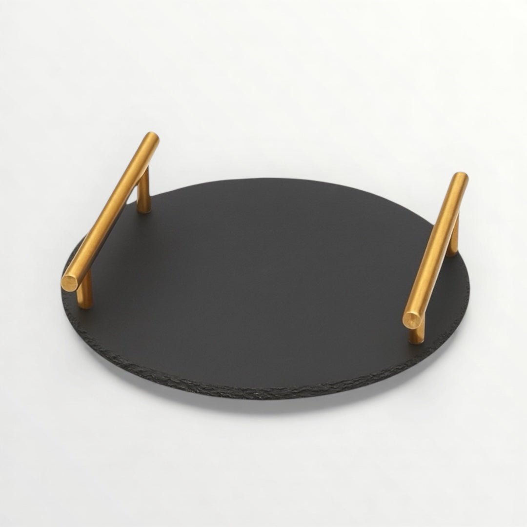 Black slate tray with gold handles on a white background
