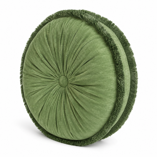 Green soft round pillow with fringed edge on a white background