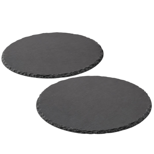 Two round black slate platters on a white background