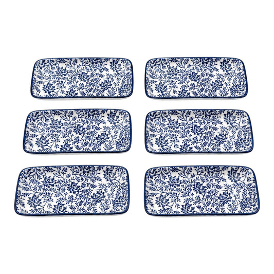 Set of six blue and white floral patterned rectangular plates on a white background