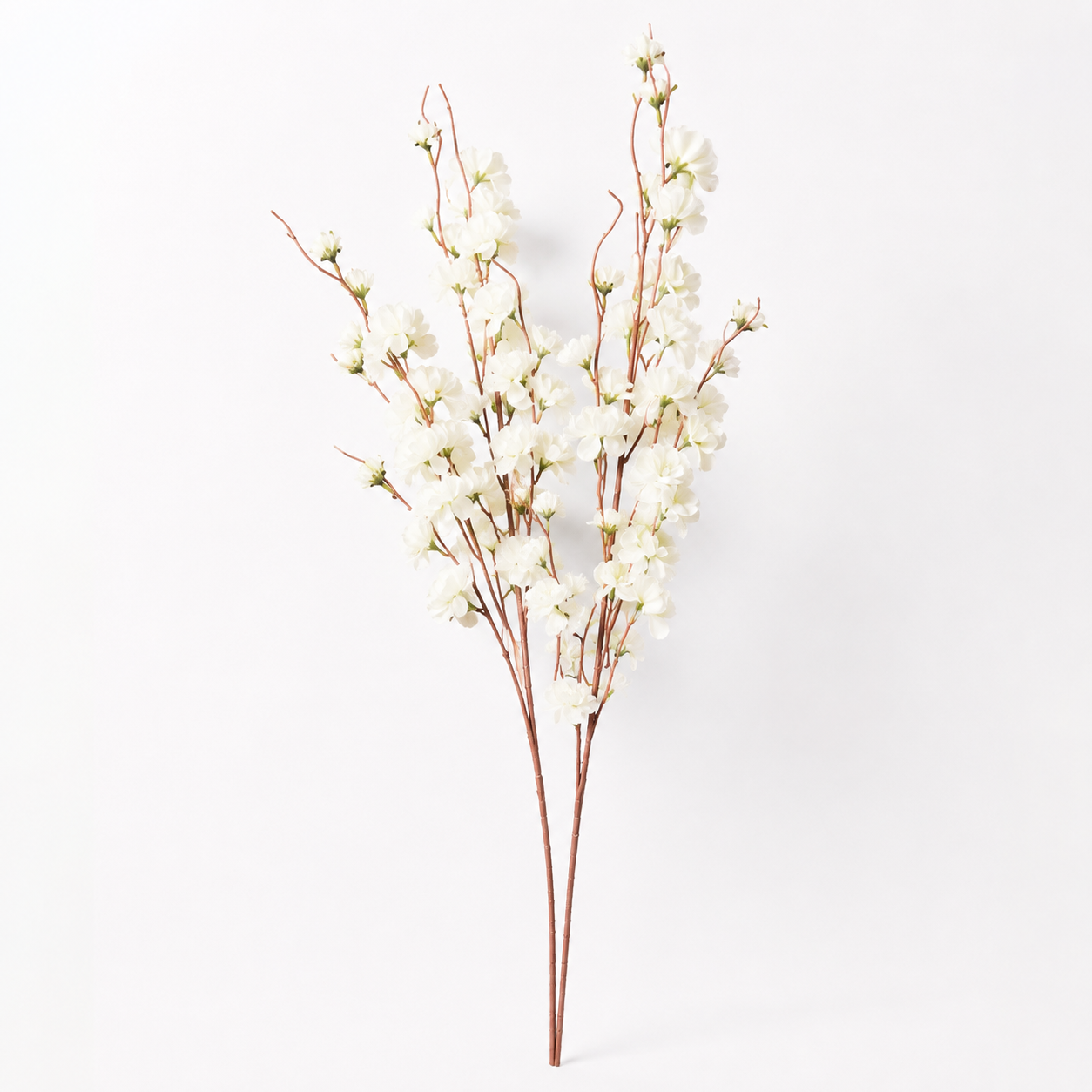 White artificial cherry blossom branches with delicate white blossoms and brown stems, photographed against a clean white background.