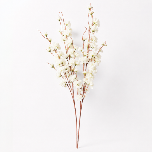 White artificial cherry blossom branches with delicate white blossoms and brown stems, photographed against a clean white background.