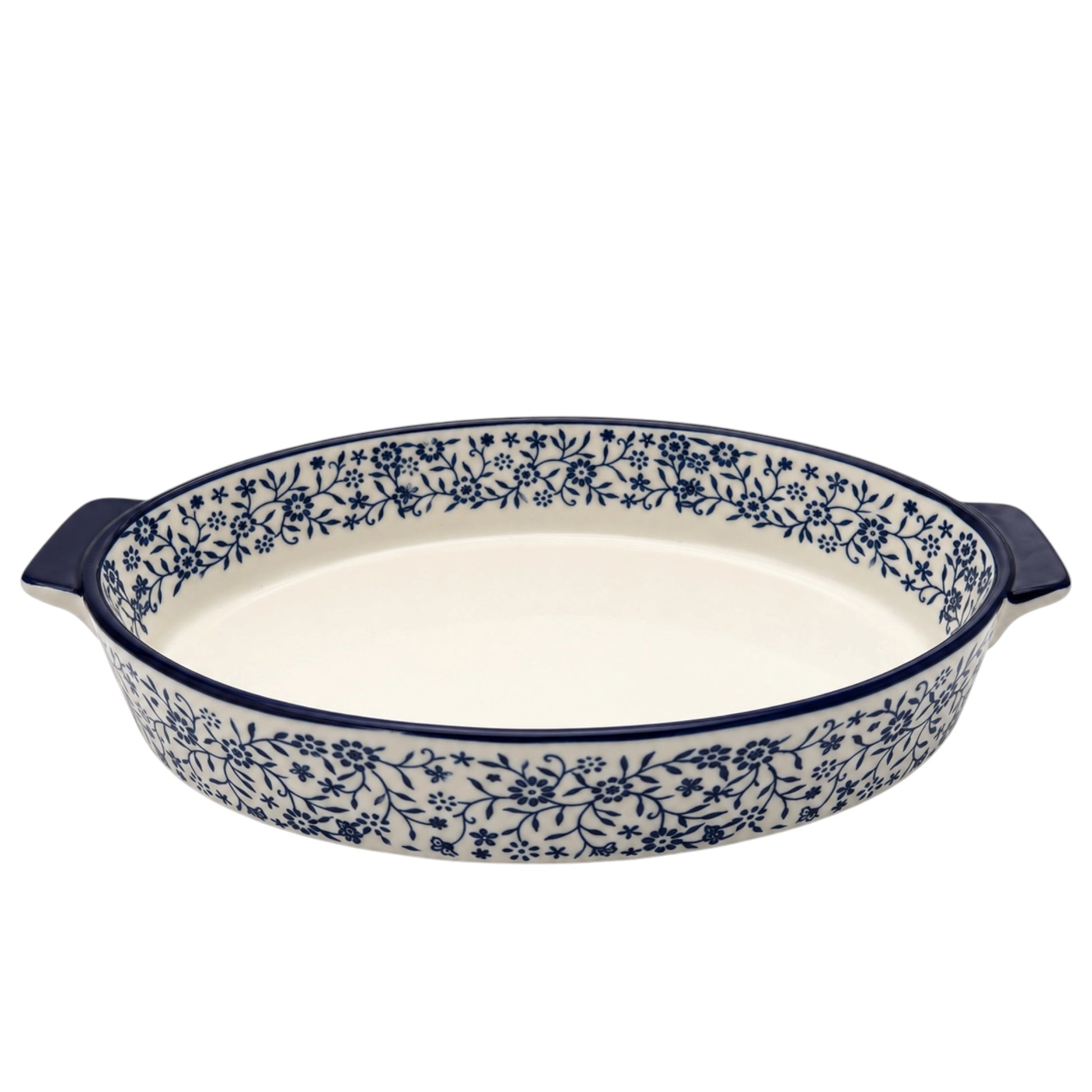 An oval ceramic baking dish with dark blue handles and a blue floral pattern around the rim, set against a plain white background.